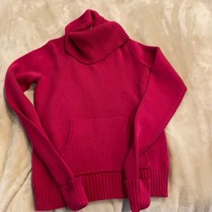Pink 100 percent cotton turtleneck sweater.